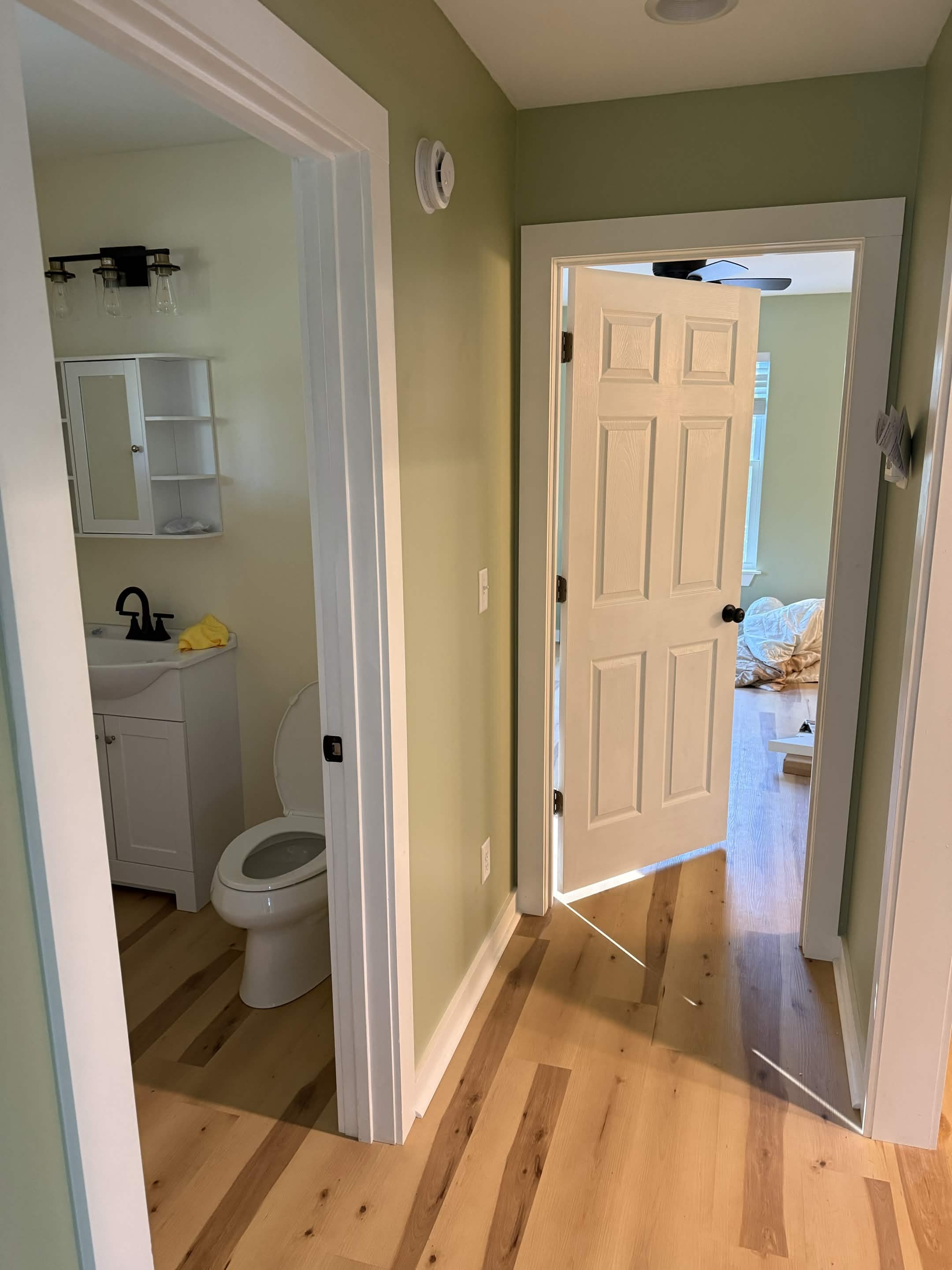 Installed interior door between finished bathroom and bedroom